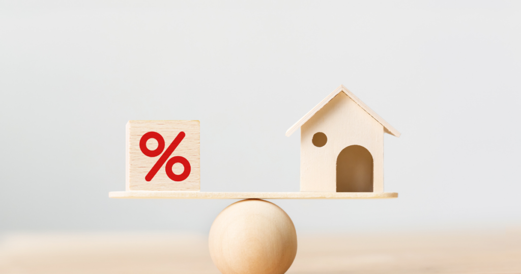 A balanced scale with the magic mortgage rate percentage on one side and a new home on the other side.